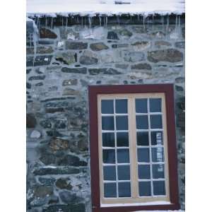 Exterior of Snow Covered Building with Stone Wall and Window in Quebec 
