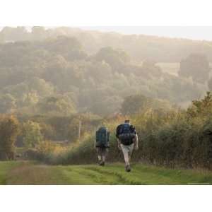 com Two Walkers with Rucksacks on the Cotswold Way Footpath, Stanway 