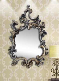 decorative mirror hangs near a lamp