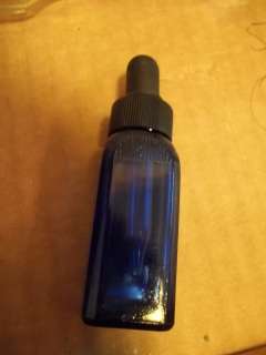 Glass bottle with cap and dropper. Cobalt. DOHO NY on bottom  
