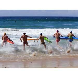  Surf Lifesavers Sprint for Water During a Rescue Board 